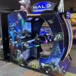 Halo: Fireteam Raven arcade cabinet with blue, futuristic walls and character artwork on panels behind the screen area.